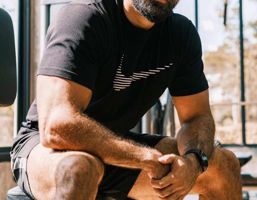 a man sitting on a bench in a gym